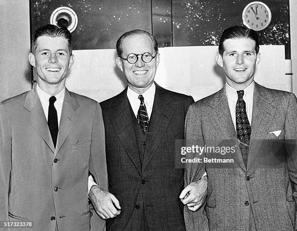 American Ambassador Joseph P. Kennedy stands with his sons John and Joseph on the deck of the ocean liner S.S. Normandie as they sailed to Britain.