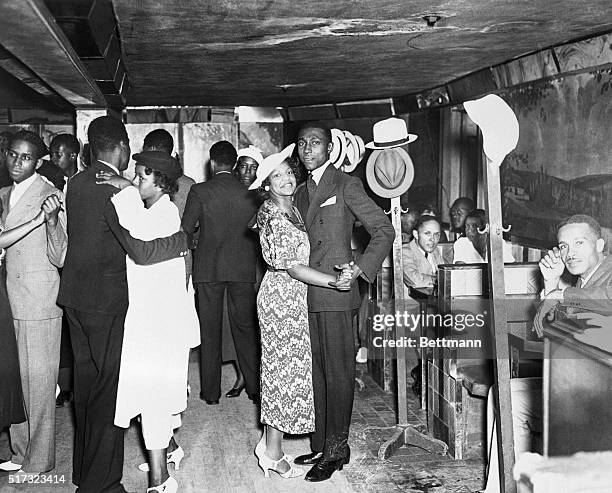 several-couples-dance-to-music-while-others-relax-in-booths-at-a-harlem-nightclub.jpg
