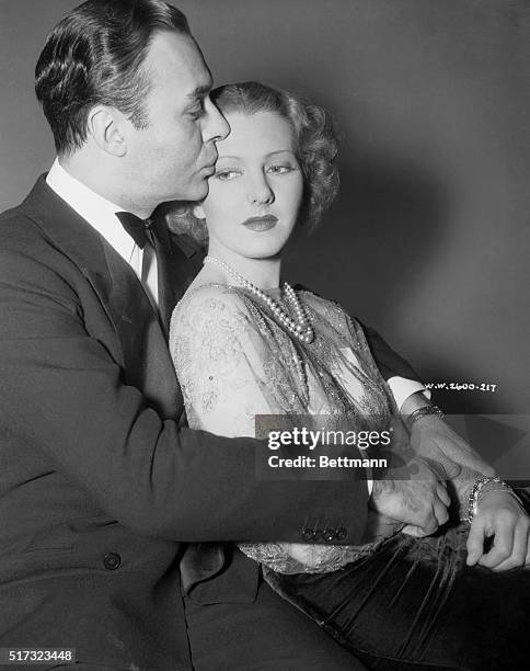 Jean Arthur and Charles Boyer, movie stars, indulging in a "Hollywood" kiss. January, 1938.