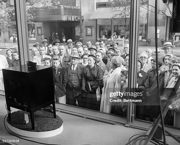 New Yorkers watching the Coronation of Queen Elizabeth on a display television.