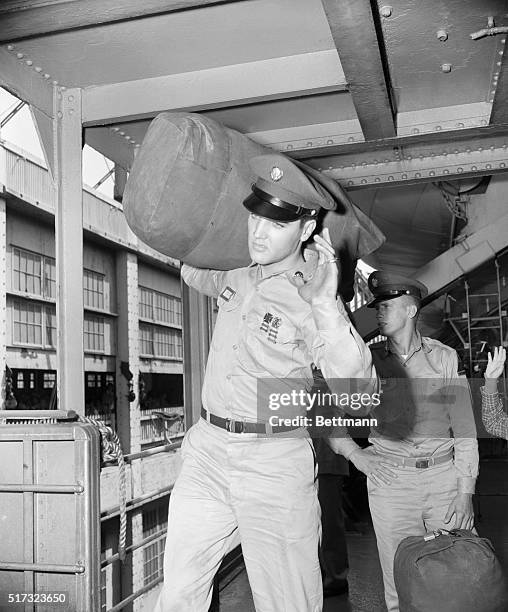 Private Elvis Presley waves goodbye before leaving Brooklyn for Europe.