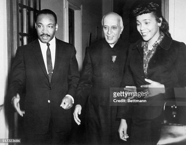 Indian Prime Minister Jawaharlal Nehru is flanked by his guests, American civil rights leader Dr. Martin Luther King and wife Coretta Scott King...