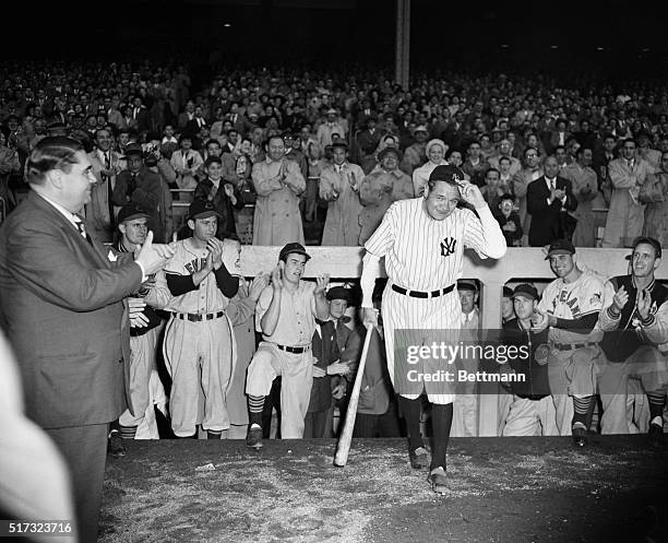 New York, NY: Babe Ruth tips his hat to the wildly cheering crowd which attended the Silver Anniversary ceremonies of the Yankee Stadium, June 13. He...