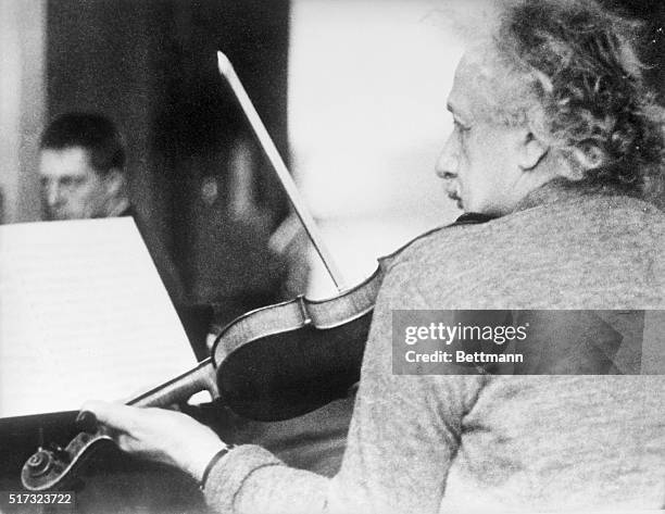 Albert Einstein playing the violin at a chamber music rehearsal in Princeton, NJ. Photograph.