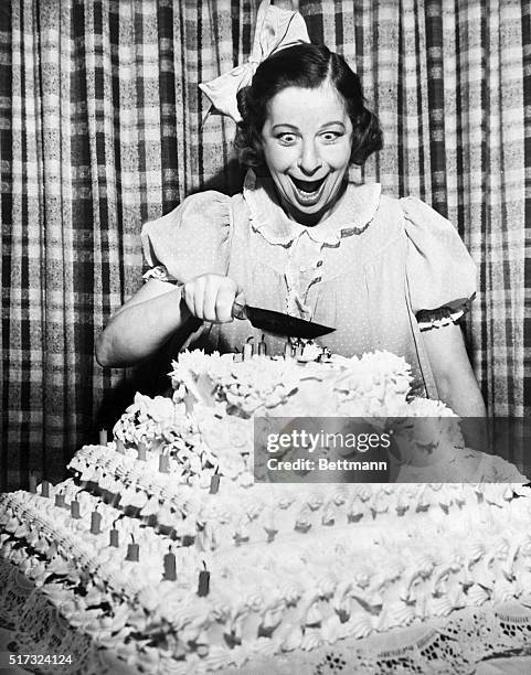 Baby Snooks, created by Fanny Brice in the 1920's, celebrates her 7th birthday with a big cake. Photograph, 1946.