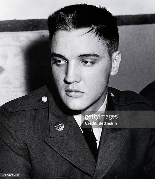 Fort Hood, TX: A weary Private Elvis Presley ponders the army's next move after arriving at Fort Hood, TX, after a day-long bus trip yesterday from...