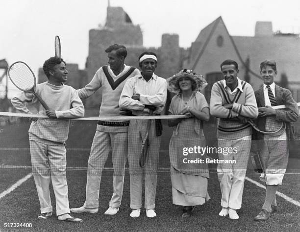 Everybody's playing tennis since Bill Tilden went out west to educate 'em. Here we have Charlie Chaplin, William Tilden II, the racquet champion;...