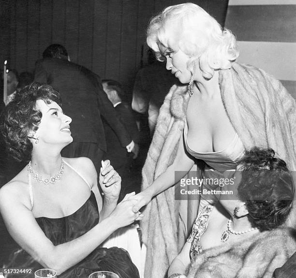 Beverly Hills, California: Italian actress Sophia Loren and glamorous Jayne Mansfield are shown as they met tonight at a gala party in Romanoff's...