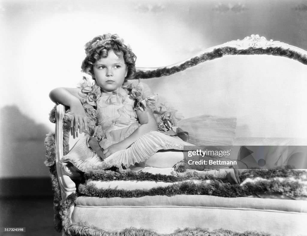 Shirley Temple Sitting On A Couch
