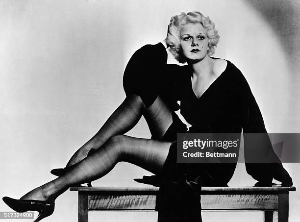 Full-length seated portrait of Jean Harlow, siren of the 1930's. Undated photograph.