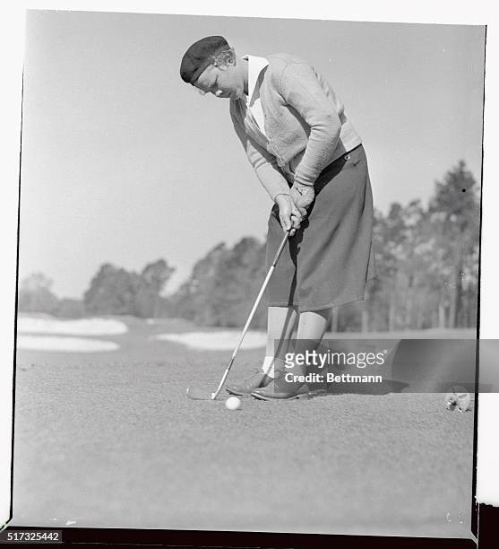 Patty Berg, youthful golf star from Minneapolis, is pictured putting during the Aiken Invitation Four-Ball Round Robin tournament at Highland Park...