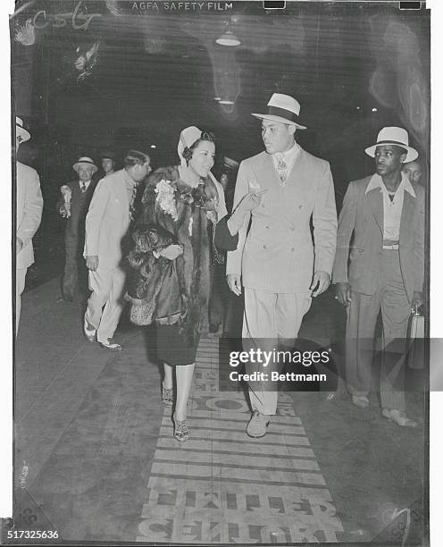 Louis and wife depart for Chicago..."And now you can listen to me for a while," Mrs. Joe Louis might well be saying to Joe Louis as they walk down to...