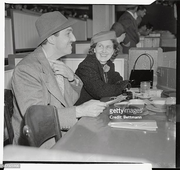 Pictured at the races at Santa Anita track recently are Mr. And Mrs. Walt Disney. They are seen in the Turf Club at the track.