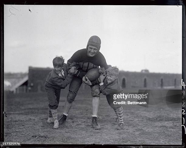 Harold "Red" Grange, with kids at Temple University.