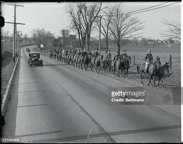 Hopewell, NJ: Horsemen of the 112th Field artillery as they filed along the road on their way to search the Sourland Mountain district for any trace...