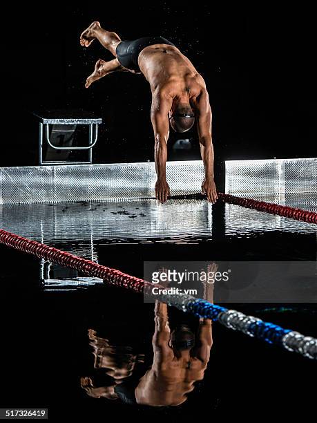 male swimmer in mid-air - high contrast athlete stock pictures, royalty-free photos & images