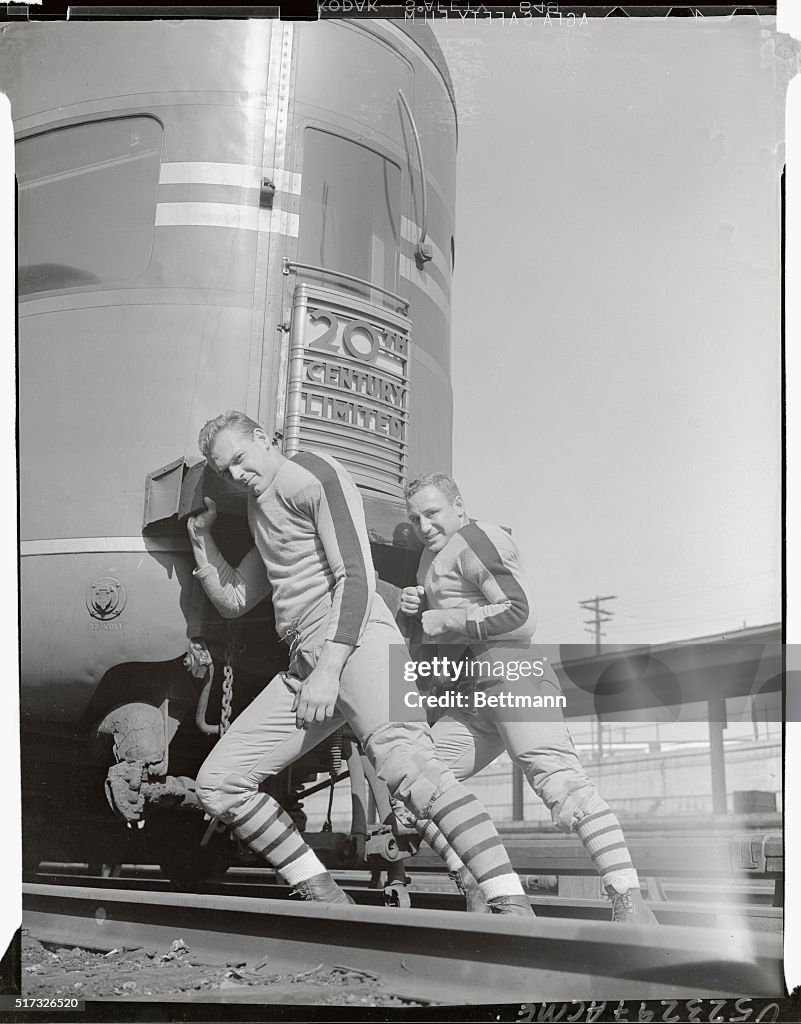 Football Players Pushing Railroad Car