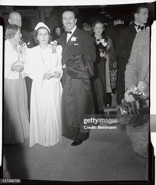 Walt Disney, accompanied by his wife, arriving for the recent Hollywood premiere of his latest production, Pinocchio.