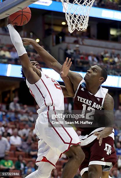 Buddy Hield of the Oklahoma Sooners goes up for a shot against Jalen Jones of the Texas A&M Aggies in the first half in the 2016 NCAA Men's...
