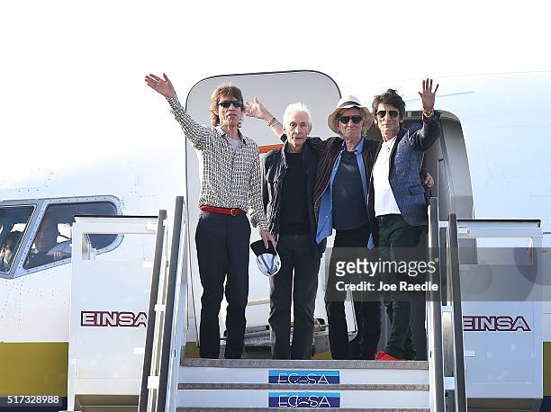 Mick Jagger, Charlie Watts, Keith Richards and Ronnie Wood of the Rolling Stones wave as they exit their plane after landing at the Jose Marti...