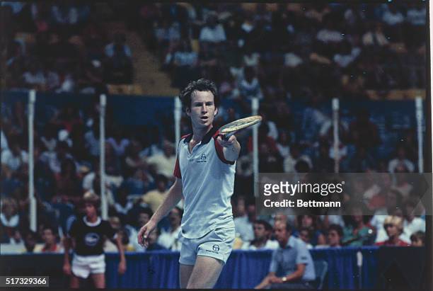 John McEnroe pointing his tennis racket during Davis Cup match against Mat. Wilander.