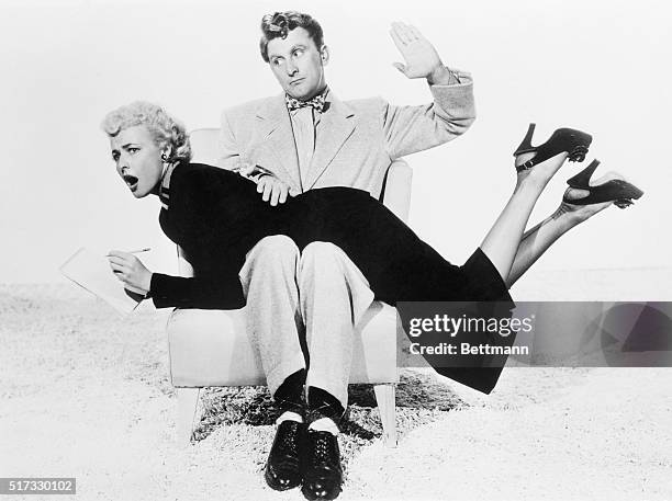 Kirk Douglas gives Laraine Day a playful spanking between scenes on the set of the new film, My Dear Secretary. This treatment is not absolutely...