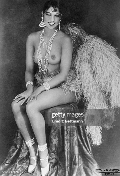 Topless Josephine Baker seated on a stool. Undated photograph.