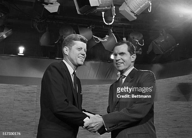Presidential candidates John F. Kennedy and Richard Nixon shake hands after their televised debate of October 7, 1960. The two opponents continued...