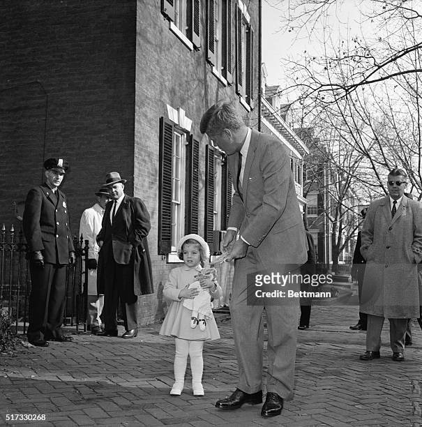 Newly-elected President John F. Kennedy walks with his daughter Caroline to church on her third birthday, November 27, 1960.