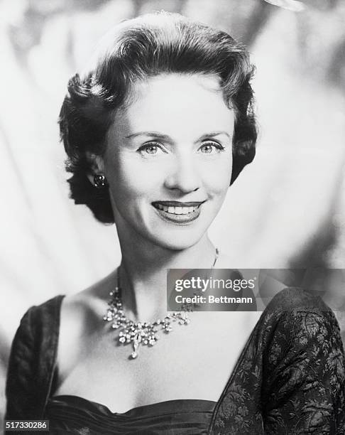 Actress Jessica Tandy- smiling head and shoulders shot, wearing jewelled necklace.