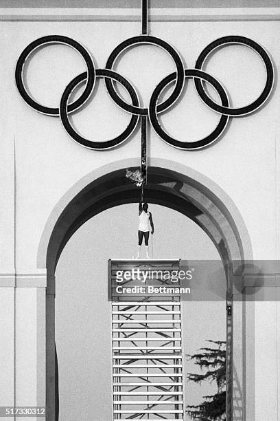 Olympic decathlon gold medal winner Rafer Johnson stands atop a stairway to light the Olympic rings which will, in turn, light the Olympic Flame at...