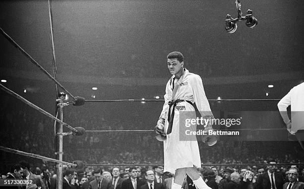 Boxer Cassius Clay paces the ring after the crowd boos his win in a 1963 bout with Doug Jones.