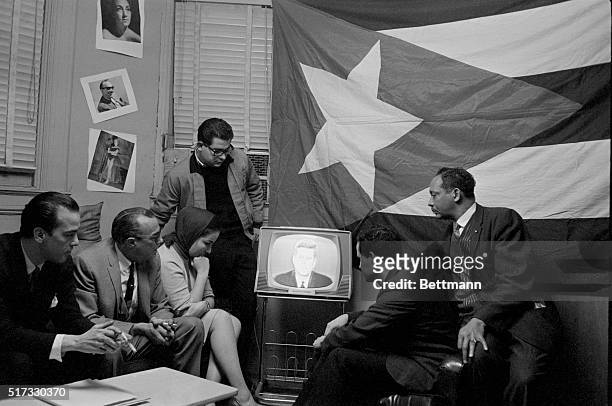 Group of Cuban refugees in Manhattan watch President Kennedy delivering a speech on television. Kennedy described a seven-point program directed at...