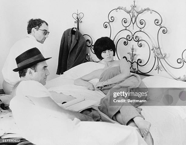 Jean-Luc Godard discusses a bedroom scene with Brigitte Bardot and Michel Piccoli on the set of Le Mepris.