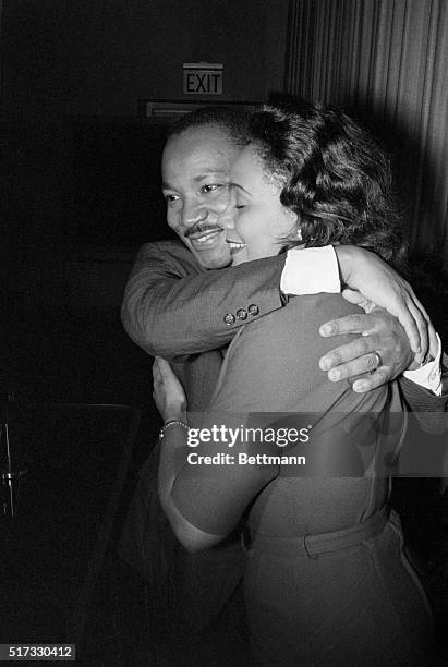 Dr. Martin Luther King, Jr. Hugs his wife Coretta during a news conference following the announcement that he had been awarded the Nobel Peace Prize.