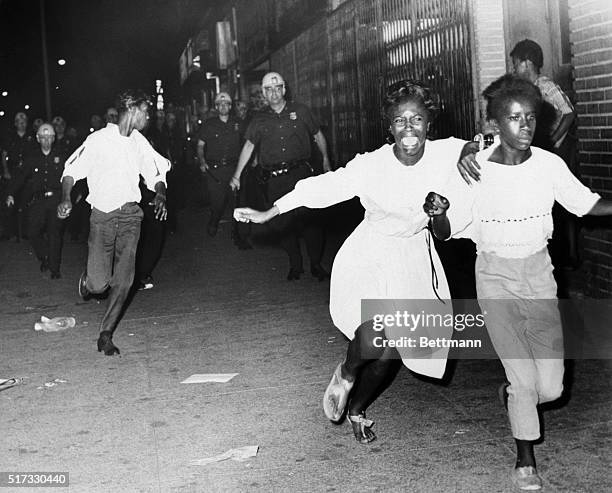 Two terrified African American girls flee police officers during a race riot in the Bedford-Stuyvesant neighborhood of Brooklyn. This is the second...