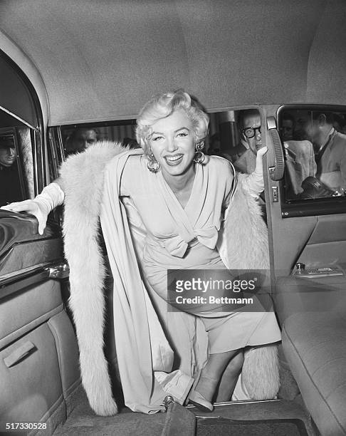 Actress Marilyn Monroe boards a car as she leaves from Idlewild Airport. Idlewild Airport is now known as John F. Kennedy International Airport.