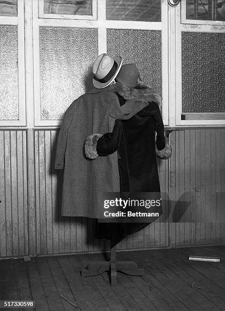 Two coats and two hats on a coat rack have been posed to look like a man and woman with their arms around each others' backs. New York, March 31,...