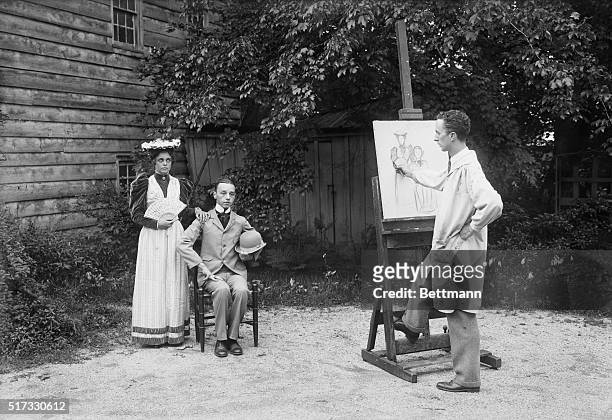 New Rochelle, New York: Norman Rockwell, modern artist, drawing modern models in his home at New Rochelle.
