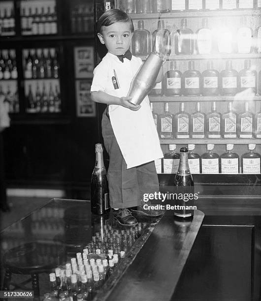 Havana, Cuba: Sloppy Joe Jr., just four years of age and having two years behind the bar, is celebrating his graduation from apprenticeship by mixing...