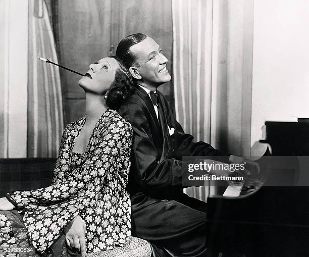 Gertrude Lawrence and Noel Coward hamming it up at the piano in a scene from the play, "Private Lives." Photograph, 1931. BPA2# 5008