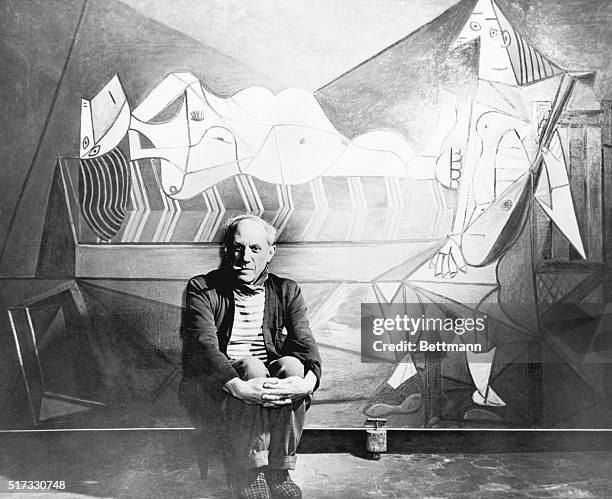 Spanish artist Pablo Picasso in front of his painting L’Aubade , at his studio in Paris, 15th December 1944.