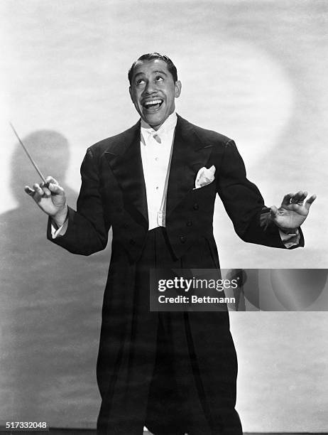 Portrait of jazz musician Cab Calloway in tails and holding a conductor's baton. Undated photograph.