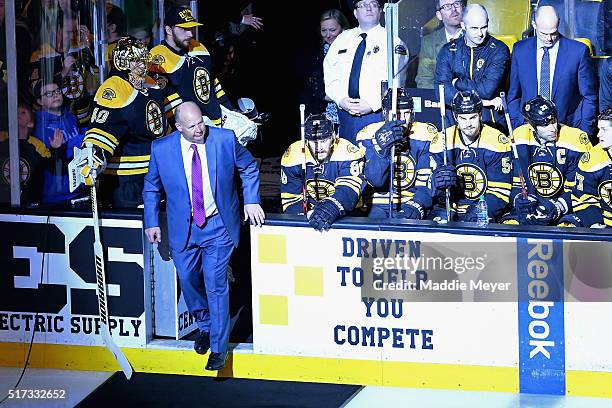 Claude Julien of the Boston Bruins enters the ice to be honored as the coach with the most wins in franchise history with 388 before the game against...