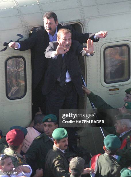 Official Yasser Abed Rabbo and presidential office advisor Ramzi Khoury plead with the crowd to make room for the coffin of late Palestinian leader...