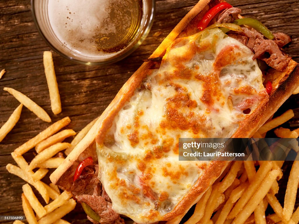 Philly Cheese Steak Sandwich with Fries and a Beer