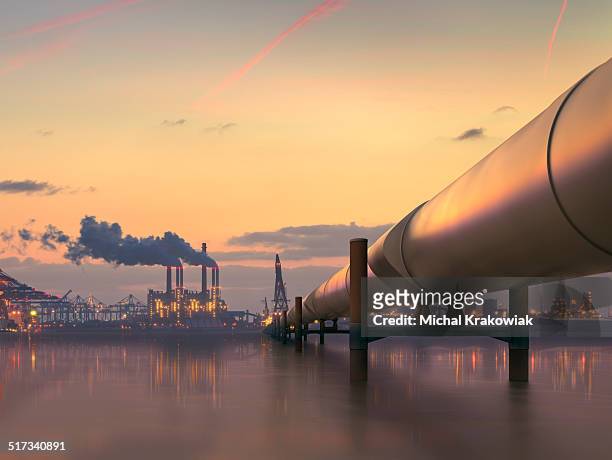 oil pipeline in industrial district with factories at dusk - crude oil stock pictures, royalty-free photos & images