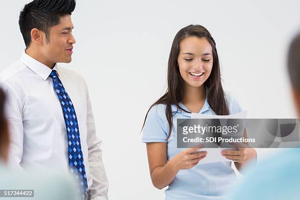 high school girl presents oral report to class - teacher in front of whiteboard stock pictures, royalty-free photos & images