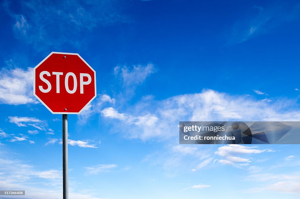 Stop Sign With Blue Sky Background and Copy Space
