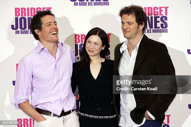 Hugh Grant , Renee Zellweger and Colin Firth pose at the photocall to promote "Bridget Jones: The Edge of Reason" at Hotel Adlon on November 11, 2004...